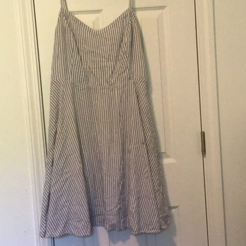 Summer dress in navy and white stripes with spaghetti straps.